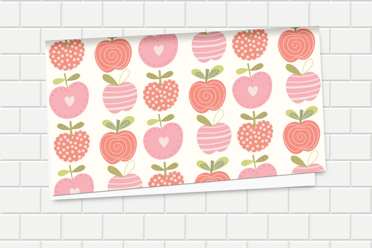 Decorative wrapping paper with pink and red apples pattern on a tiled wall background