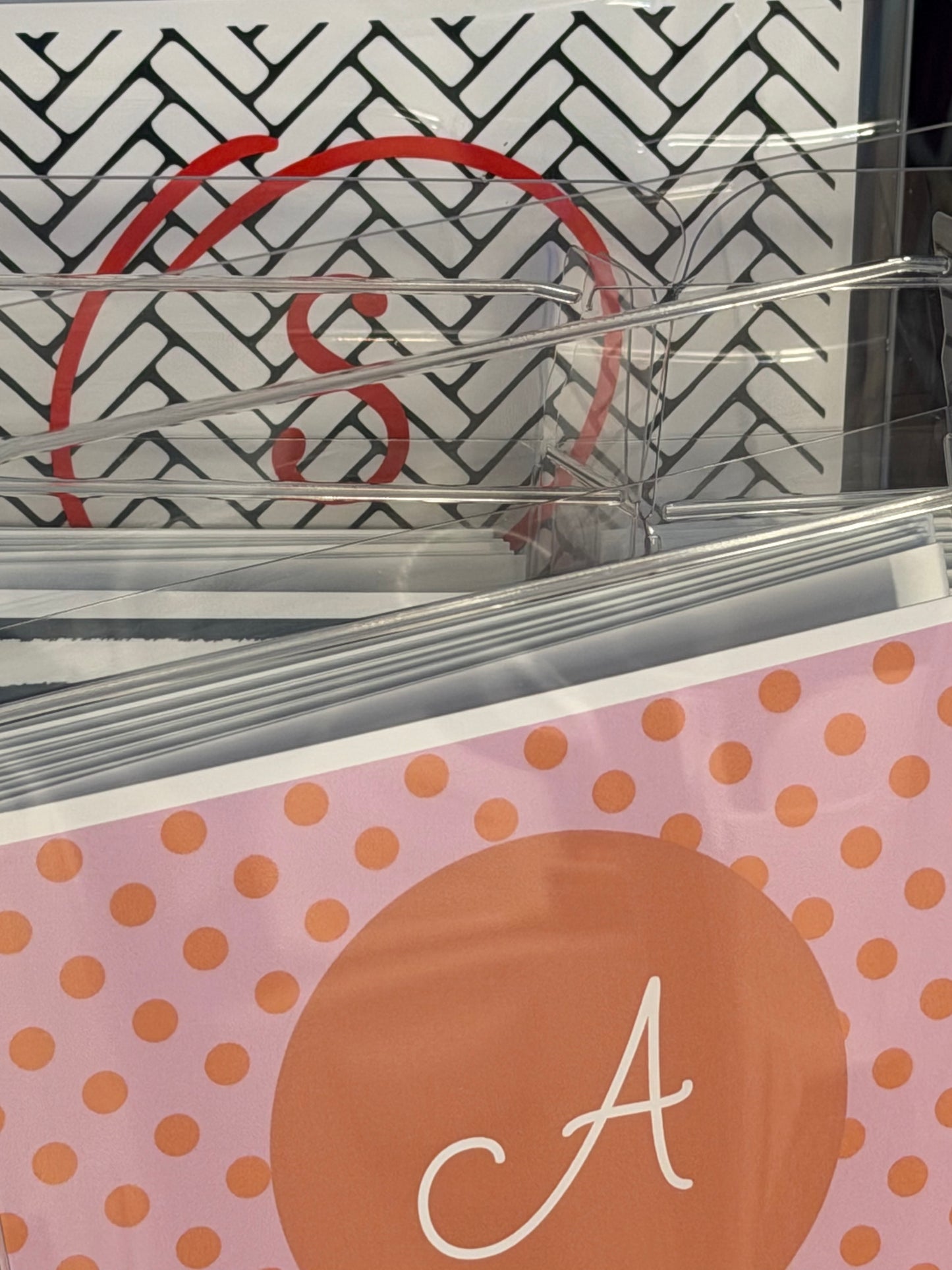 Clear plastic holder with a pink and orange polka dot design featuring the letter 'A'.