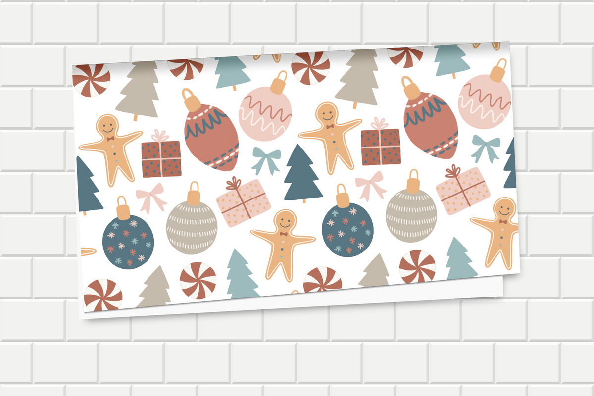 Christmas-themed wrapping paper with gingerbread men, ornaments, and trees on a white background