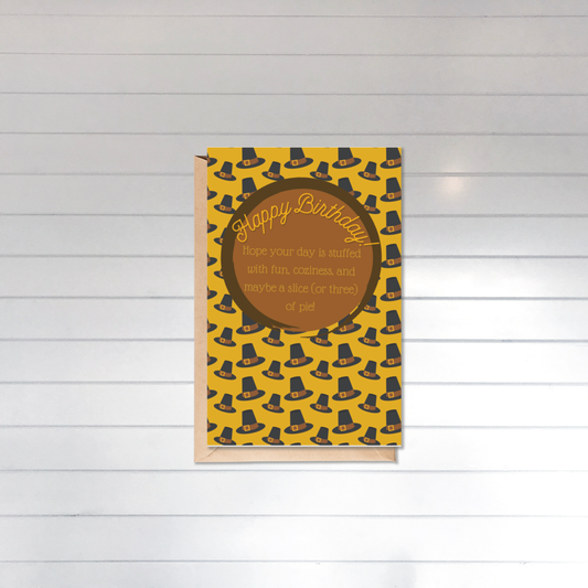 Birthday card with pilgrim hat pattern on a wooden surface