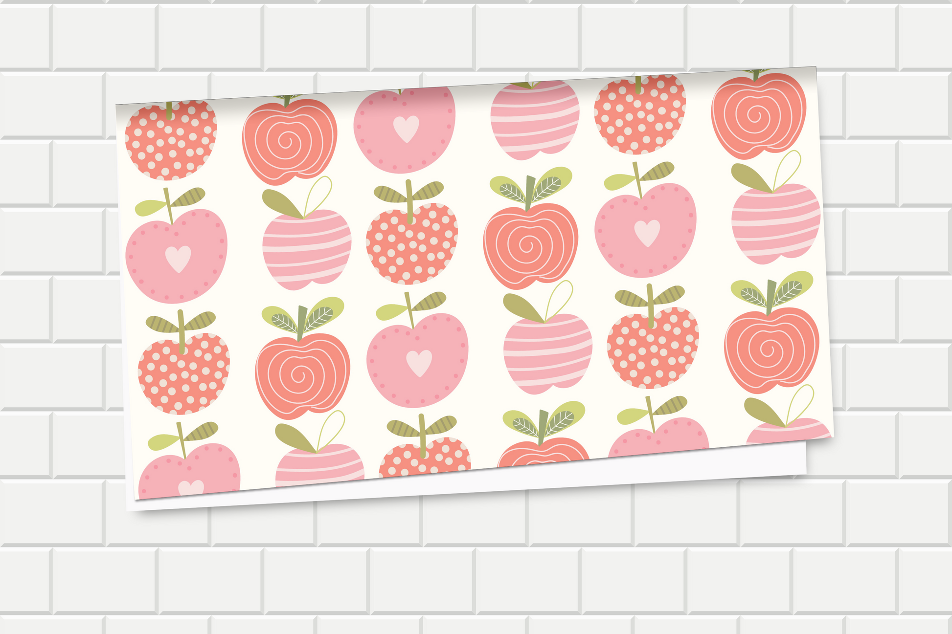 Wrapping paper with pink and red apples pattern on a tiled wall background