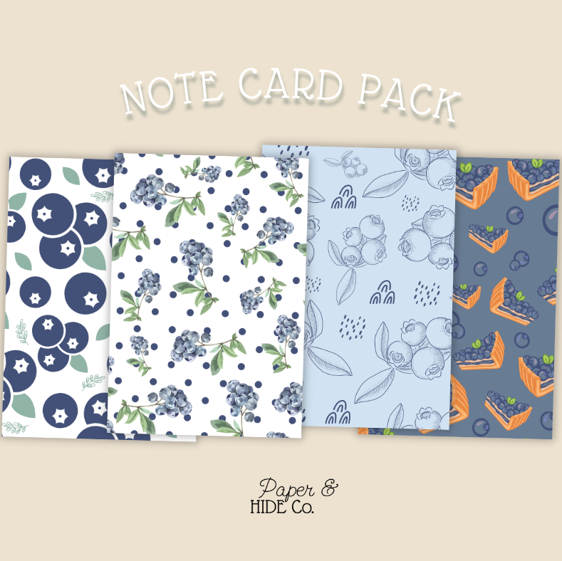 Note card pack with floral and blueberry designs on a beige background, featuring the brand 'Paper & Hide Co'.