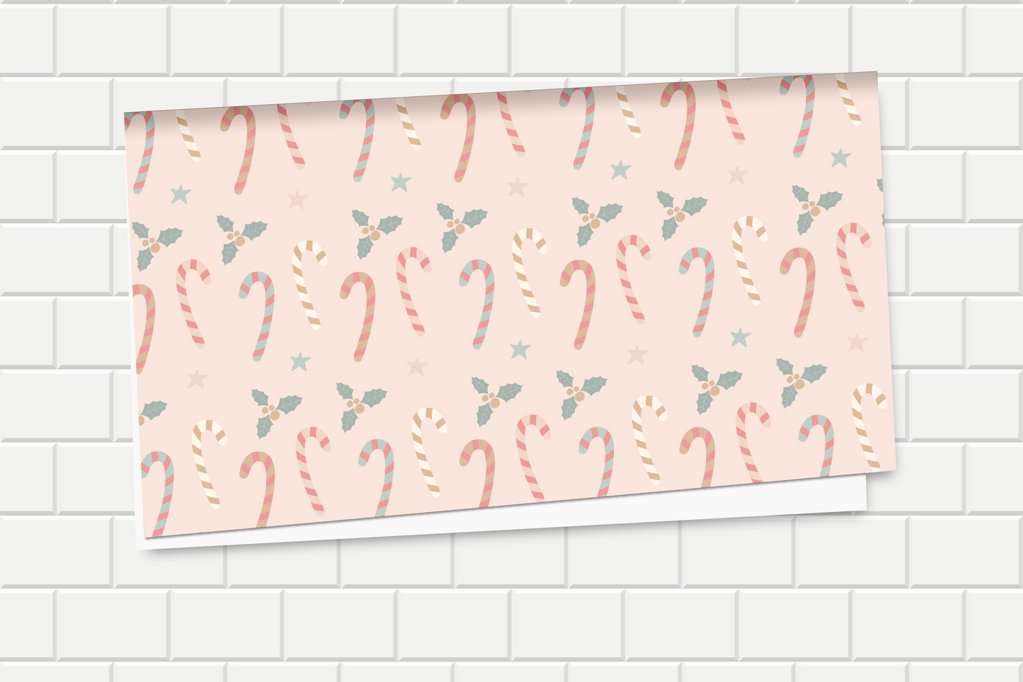 Roll of paper with candy cane pattern on a tiled wall background