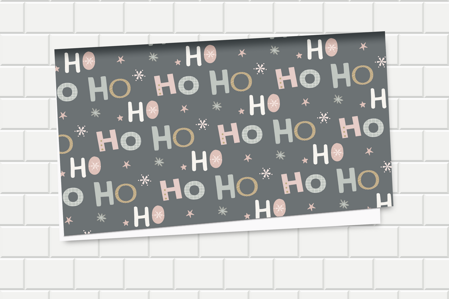 Decorative wrapping paper with 'HO HO HO' pattern on a tiled wall background