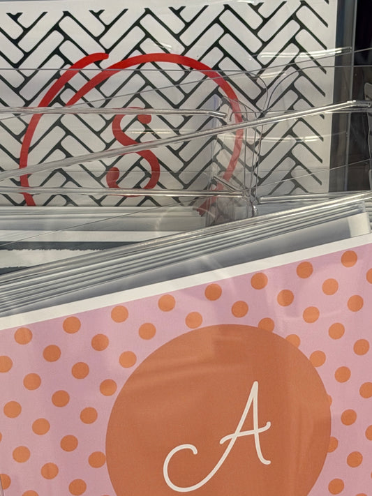 Clear plastic holder with a pink and orange polka dot design featuring the letter 'A'.