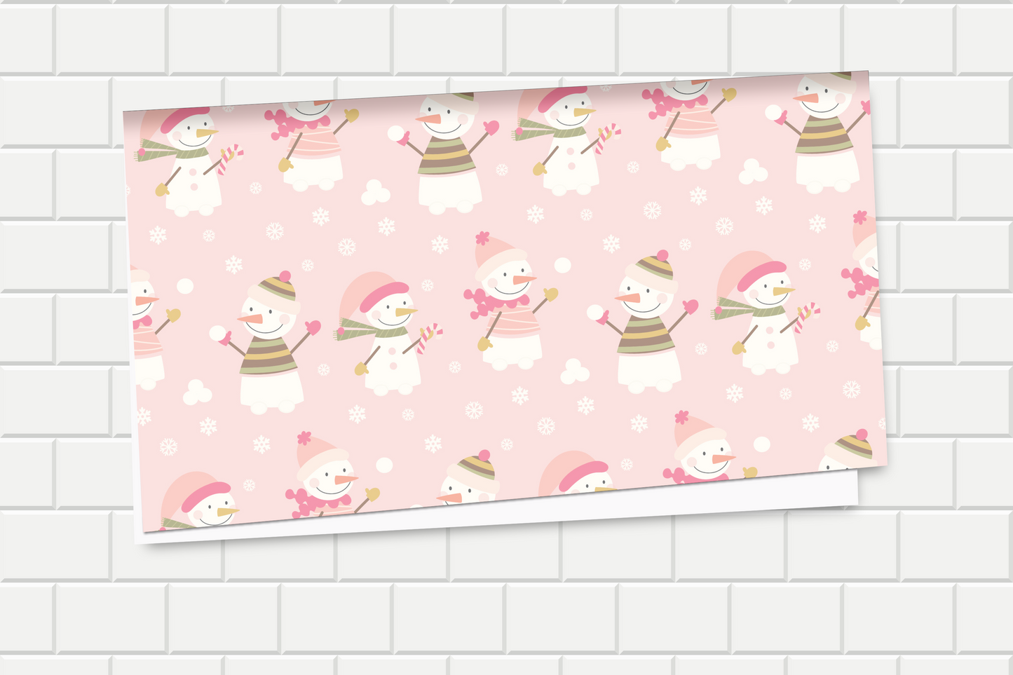 Pink paper with snowman pattern on a tiled wall background