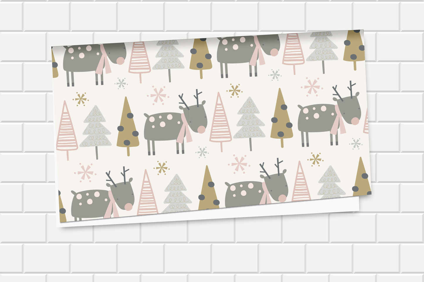 Wrapping paper with Christmas-themed pattern featuring reindeer and trees on a white tiled background