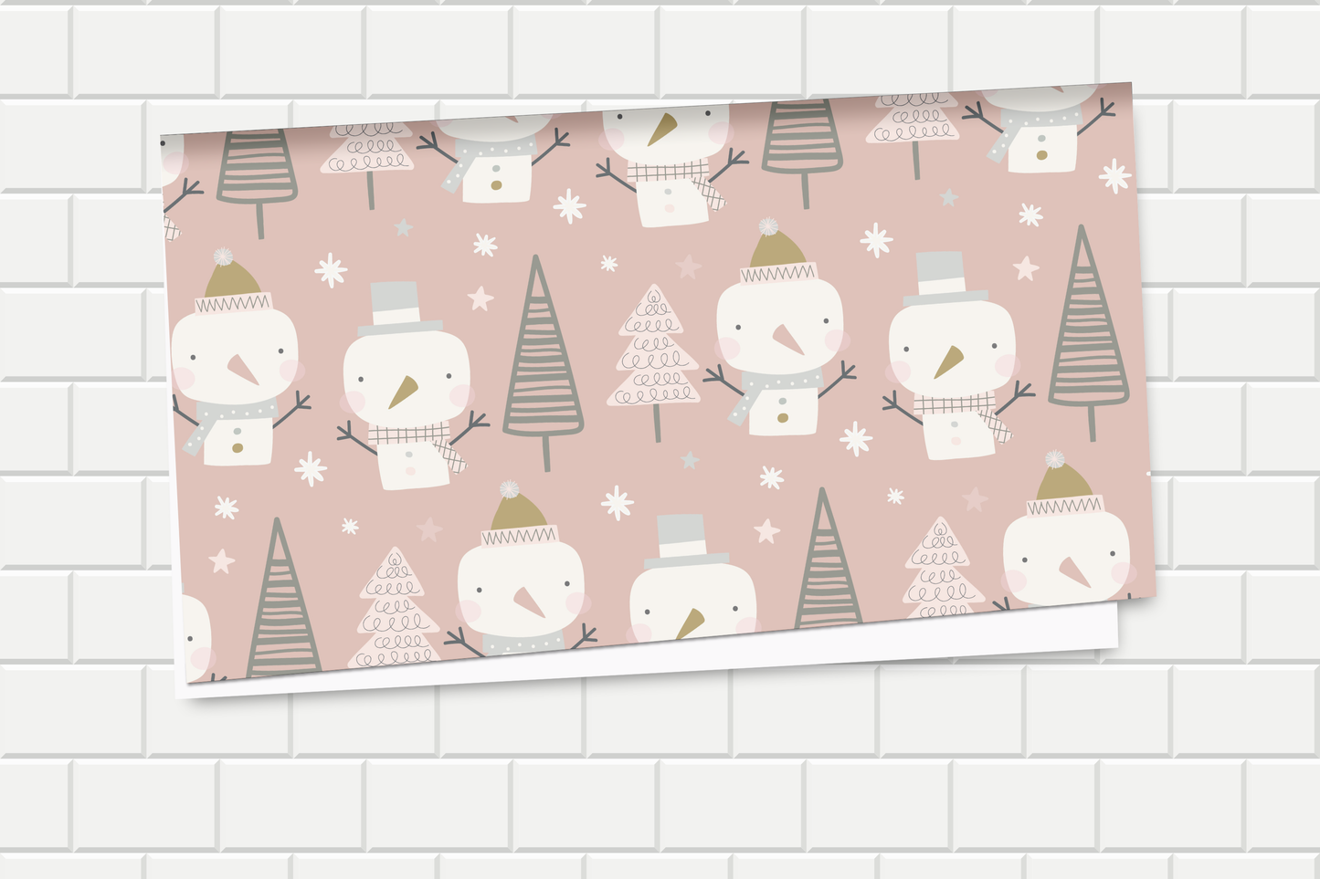 Festive wrapping paper with snowman and tree pattern on a pink background