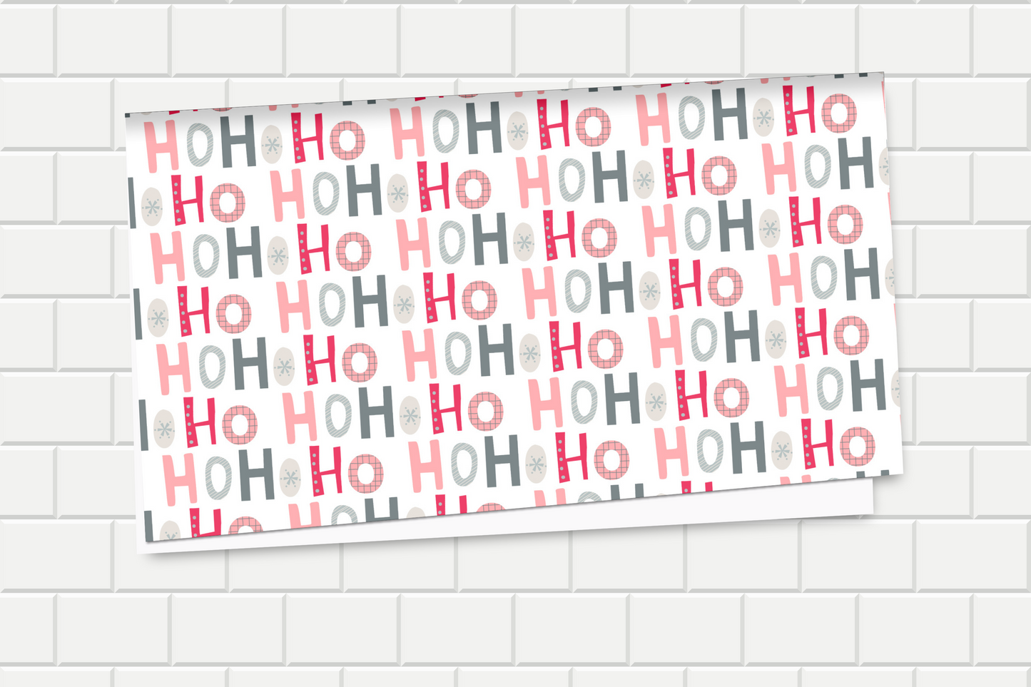 Wrapping paper with 'HO HO HO' pattern on a tiled wall background